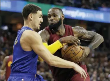  ?? TONY DEJAK — THE ASSOCIATED PRESS ?? The Cavaliers’ LeBron James, right, drives to the basket against Golden State’s Klay Thompson Sunday in Cleveland. The Cavaliers won 109-108.