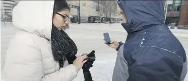  ?? IAN KUCERAK ?? U of A researcher Rob Shields, right, and intern Nathalia Osorio use smartphone apps to study walking patterns and signal lights.