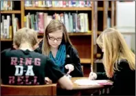  ?? NWA Media/JASON IVESTER ?? Springdale High sophomores Garrett Story (from left), Cassidy King and Allie Dill study for their final exams Friday in the school library. A U.S. Education Department grant will help the district rethink high school and focus on individual learning...