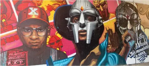  ?? ROBERT HERGUTH/ SUN-TIMES ?? BELOW: This mural at Hubbard and Green streets by Chicago artist Rahmaan Statik shows three versions of Daniel Dumile, the late rapper and hip-hop artist better known as MF DOOM.