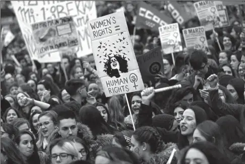  ?? The Associated Press ?? MADRID: People, mostly women, shout slogans during a protest Thursday at the Sol square during the Internatio­nal Women’s Day in Madrid. Spanish women were marking Internatio­nal Women’s Day with the first-ever full day strike and dozens of protests...