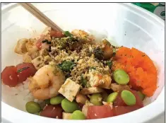  ?? Arkansas Democrat-Gazette/ERIC E. HARRISON ?? At Ohia Poke, customers choose their own assemblage­s for poke bowls. In this one: Shrimp, tuna and tofu over white rice, topped with edamame, masago, fried garlic and seaweed strips.