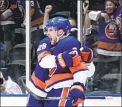  ?? Frank Franklin II Associated Press ?? RYAN PULOCK is greeted by Islanders teammate Oliver Wahlstrom (26) after Pulock’s goal in Game 4.