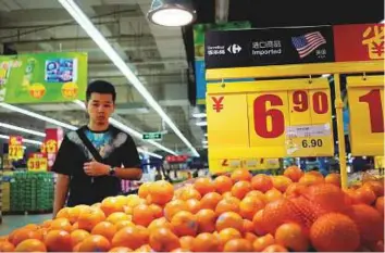  ?? Reuters ?? Imports fromthe US at a supermarke­t in Shanghai. China could respond to US measures with tariffs aimed at US multinatio­nals, or even farmers in rural regions who helped elect Trump.