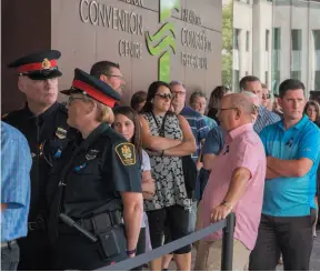  ?? CP PHOTO ?? Mourners line up outside the Fredericto­n Convention Centre, where a public visitation for Fredericto­n police constables Sara Burns and Robb Costello was held on Thursday.