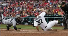  ??  ?? Washington Nationals’ Stephen Strasburg (37) slides safely into home as San Diego Padres catcher Austin Hedges (left), cannot make the tag in time, on a fielder’s choice, during the third inning of a baseball game at Nationals Park on Saturday in...