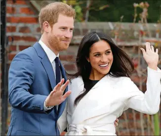  ?? CHRIS JACKSON / GETTY IMAGES ?? Prince Harry and Meghan Markle, then newly engaged in November 2017, pose during a photo shoot at Kensington Palace.