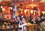  ?? PHOTOS BY LIU XUAN / CHINA DAILY ?? The gift shop at Laoshe Teahouse; customers watch performanc­es at Laoshe Teahouse; Lei Lei brings her friend Steven, from the UK, to experience the tea culture.