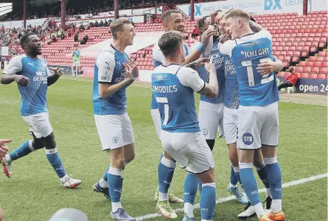  ?? Photo: Joe Dent/theposh.com. ?? Jack Taylor (left of main bunch) tries to tell his teammates that he scored the second goal at Barnsley!