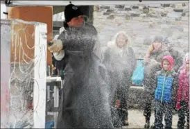  ?? NEWS-HERALD FILE ?? George Niemoeller of Elegant Ice Creations sprays ice shavings while carving an ice sculpture of Olaf during a previous Frozen Fest.