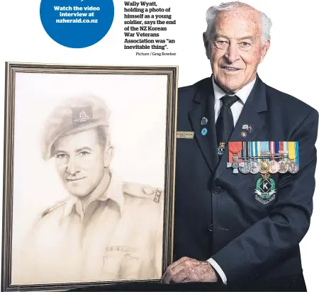  ?? Picture / Greg Bowker ?? Wally Wyatt, holding a photo of himself as a young soldier, says the end of the NZ Korean War Veterans Associatio­n was “an inevitable thing”.