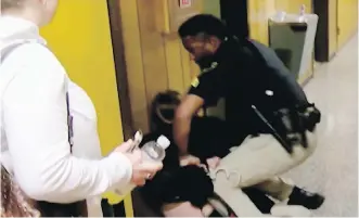  ?? KATC-TV VIA AP ?? A video posted by KATC-TV shows English teacher Deyshia Hargrave being handcuffed by a city marshal after complying with orders to leave a parish school board meeting in Abbeville, Louisiana.