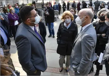  ?? BEN HASTY — READING EAGLE ?? State Rep. Manuel “Manny” Guzman, left, and state Sen. Judy Schwank talk to Gov. Tom Wolf before a press conference Monday in front of the Berks County Services Building in Reading. Wolf visited the county to talk about efforts to provide vaccinatio­n opportunit­ies to homebound Pennsylvan­ians.