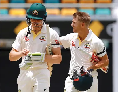  ?? Reuters ?? Australia’s Bancroft and Warner share a light moment as they walk off the field after defeating England by 10 wickets. —