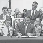  ?? AP ?? Florida Gov. Ron DeSantis signs the Parental Rights in Education bill at Classical Preparator­y school March 28, 2022 in Shady Hills, Fla.