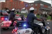  ??  ?? Two police officers ride on motorcycle­s along Washington Street in Royersford during National Night Out Tuesday evening.