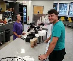  ?? By Joseph B. Nadeau photo ?? Matt Rivard, of Woonsocket, picks up his order from Jerrica Saez at the new Aroma CT Cafe at Cumberland Hill and Mendon roads. The business opened last week and will have a grand opening in the near future.