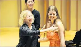  ??  ?? COMPOSER ANNE LEBARON, left, thanks the artists who performed her songs during the SongFest 2015 concert series at Colburn School’s Zipper Hall.