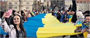  ?? ?? Ukrainian supporters in Prague carried a giant flag during a demonstrat­ion yesterday on the medieval Charles Bridge