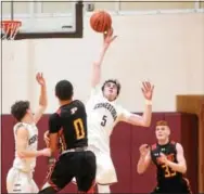  ?? PETE BANNAN — DIGITAL FIRST MEDIA ?? Conestoga’s Charlie Martin blocks a shot from Penncrest’s Tyler Norwood in the second half Friday.