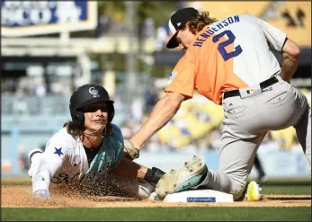  ?? KEVORK DJANSEZIAN — GETTY IMAGES ?? Zac Veen of the National League steals third base against Gunnar Henderson ( 2) of the American League during the Siriusxm All- Star Futures Game at Dodger Stadium on July 16, 2022, in Los Angeles.