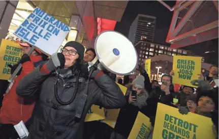  ?? ERIC SEALS/DETROIT FREE PRESS ?? Rep. Rashida Tlaib, who represents Michigan’s 13th district, talks with the GM Poletown protesters outside Cobo Center during the start of the North American Internatio­nal Auto Show Charity Preview at Cobo Center in Detroit on Jan. 18.