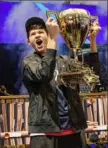  ??  ?? Kyle Giersdorf celebrates Sunday as he holds up the trophy after winning the Fortnite World Cup solo finals in New York.