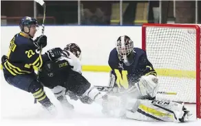  ?? IAN KUCERAK ?? MacEwan’s Dallas Smith drives to the net but he’s denied by NAIT Ooks goaltender Patrick Gora during Game 1 of the ACAC men’s hockey final on Friday. The Griffins were 7-3 winners.