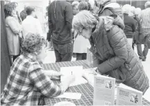  ??  ?? Sandra Phinney was one of the speakers for this year’s Showcase of Argyle. Here she signs a copy of her book, Waking Up in My Own Backyard, during the Taste of Argyle. The “showcase” and “taste” events together make up Experience of Argyle, which is held annually.