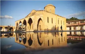  ?? — AFP ?? MORPHOU: A man walks past the Greek Orthodox church of Saint Mamas in the town of Morphou in the self-proclaimed Turkish Republic of Northern Cyprus.