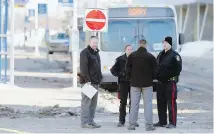  ?? JOHN WOODS, CP ?? Police investigat­e at the scene of a fatal stabbing of a bus driver at the University of Manitoba in Winnipeg this week.