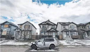  ?? JEFF MCINTOSH THE CANADIAN PRESS ?? Tens of thousands of Calgary homes suffered damage in Saturday’s major hailstorm, which also flooded streets. Mayor Naheed Nenshi estimated the storm caused at least $1 billion in damage.