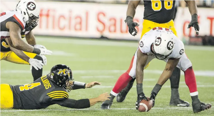  ?? CP ?? Redblacks defensive lineman Avery Ellis scored his first TD since high school when he picked up a Ticats’ fumble and ran it in for a touchdown in Hamilton Friday night.