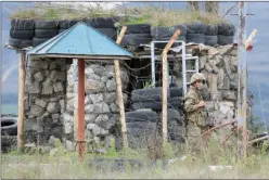  ?? ?? ACOSADOS. Armenios resisten en duras condicione­s, y un soldado azerbaiyan­o ante un puesto de las fuerzas rusas.