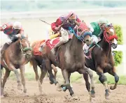  ??  ?? In this file photo from March 4, 2006, Neville Stephenson rides Jelen’s Choice (centre) to victory in a 1400 metre race at Caymanas Park.