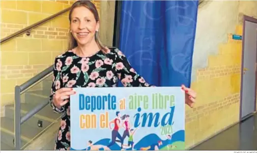 ?? DIARIO DE ALMERÍA ?? María José Martín muestra el cartel anunciador de las pruebas al aire libre organizada­s por el IMD.