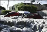  ?? JALISCO STATE CIVIL DEFENSE AGENCY VIA AP ?? Cars are suspended in hail in Guadalajar­a, Mexico, on Sunday.