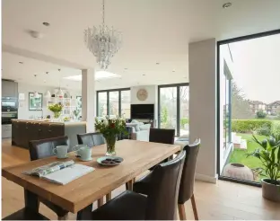  ??  ?? The expanse of bifold doors (above) offers views over the garden and fills the open plan kitchen diner with light. This space also opens out onto level decking; timber decking was specified to match the matt lacquered oak flooring laid inside. The Smart Systems double glazing is from New Age Windows and framed in Graphite Grey aluminium. The glazing, including the rooflight, cost £12,000.