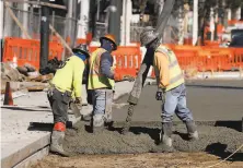  ??  ?? Concrete is poured as constructi­on on the Van Ness Improvemen­t Project, in progress since 2016, continues.