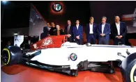  ?? Reuters ?? Sauber Holding AG president Pascal Picci (left) and FCA group CEO Sergio Marchionne (second left) pose next to Alfa Romeo Sauber F1 car during a presentati­on in Milan. —