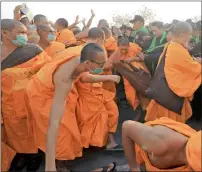  ?? Reuters ?? Buddhist monks scuffle with police after they defied police orders to leave the temple in Pathum Thani, Thailand. —