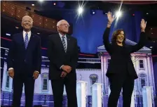  ?? AP FILE ?? WIN OR LOSE: Democratic presidenti­al candidates former vice president Joe Biden, Sen. Bernie Sanders and Sen. Kamala Harris stand on stage for a photo op before the start of the the Democratic primary debate