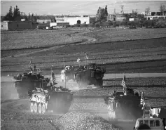  ??  ?? A convoy of US forces armoured vehicles drives near the village of Yalanli, on the western outskirts of Manbij. — AFP photo