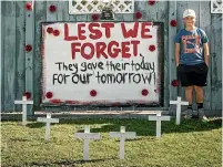  ??  ?? Charlie Ngaheke, 9, created an Anzac display outside his grandfathe­r’s house; right, Wainuiomat­a Valley RSA president Bart Bartlett will be standing on his driveway by his poppies at dawn on Anzac Day.