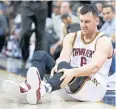  ??  ?? The Cavaliers’ Andrew Bogut reacts after getting hurt on Monday.