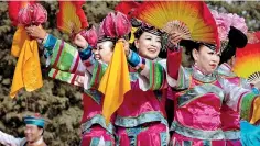  ?? ?? Performers dance at a local fair in Beijing in China to mark the New Year celebratio­ns.