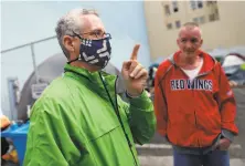  ?? Scott Strazzante / The Chronicle ?? STREET SAVVY: Jeff Kositsky, head of Healthy Streets Operations Center, tells Richard van Dusen where he can go to take a shower.