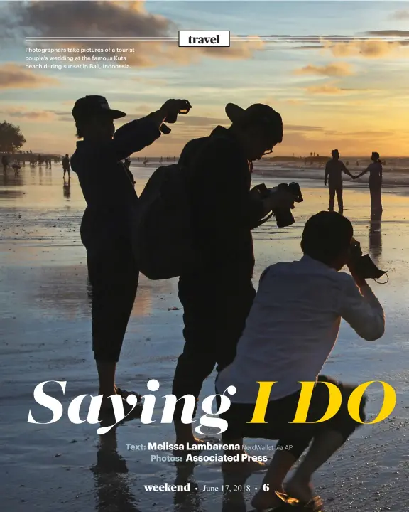  ??  ?? Photograph­ers take pictures of a tourist couple's wedding at the famous Kuta beach during sunset in Bali, Indonesia.