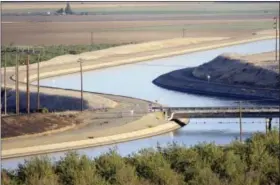  ?? RUSSEL A. DANIELS — THE ASSOCIATED PRESS FILE ?? FILE- In this file photo, in California’s Westland Water District of the Central Valley, canals carry water to southern California. A new federal audit says the federal government improperly spent tens of millions of dollars on the California water...