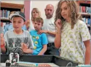 ??  ?? Team Batbot’s Jackson Krol, 12, right, and Jacob Higgins, 10, take part in the Oneida Public Library’s Lego robotics summer camp on Friday, Aug. 24, 2018.